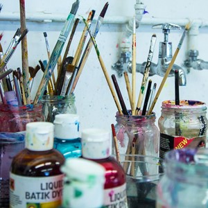 paints, brushes and jars of water