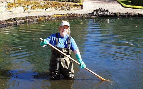 Charlotte Paterson cleaning out a pond