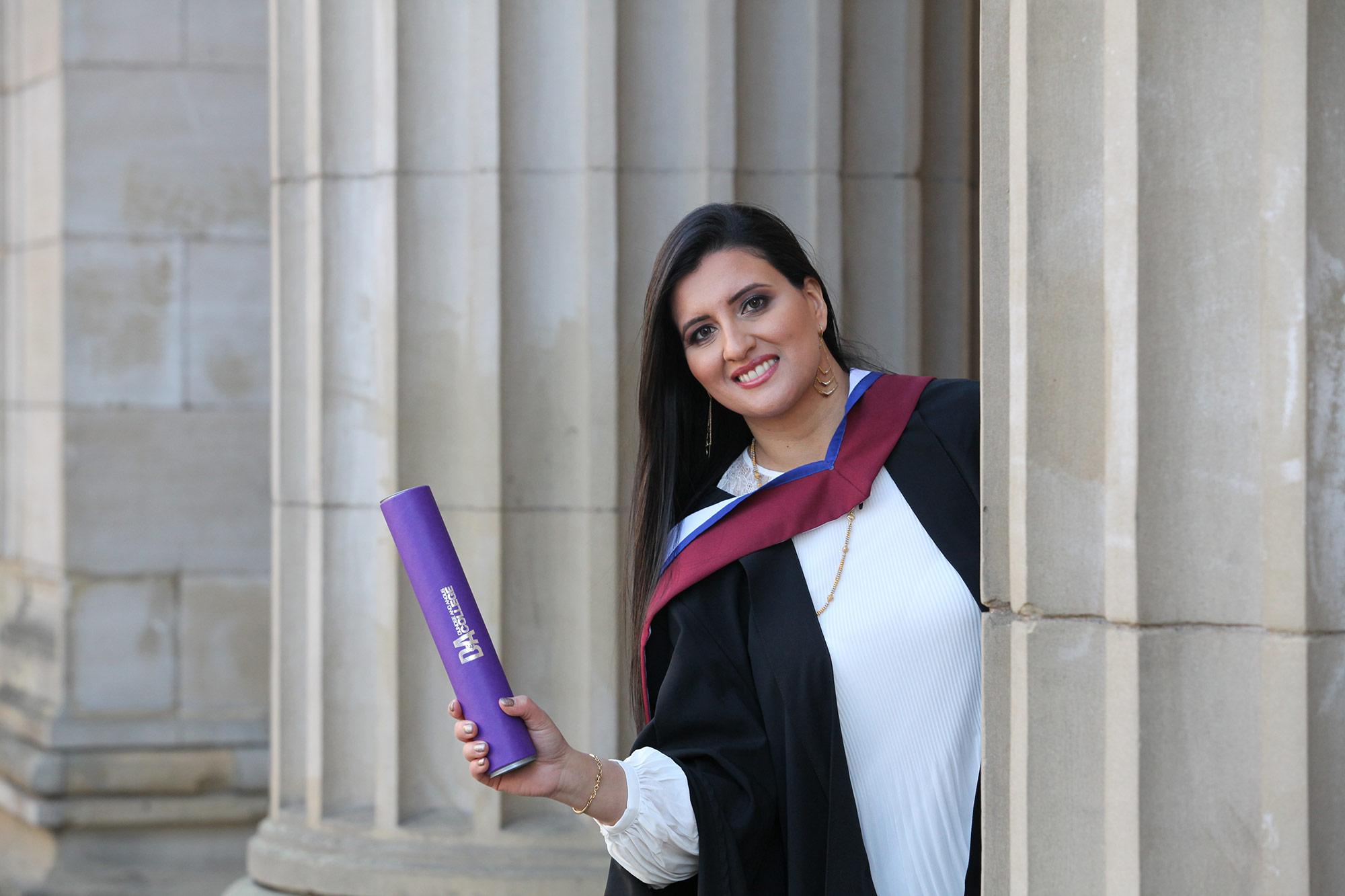 student outside caird hall for graduation