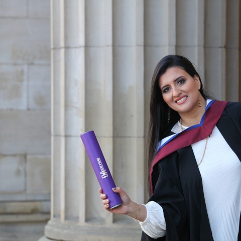 student outside caird hall for graduation