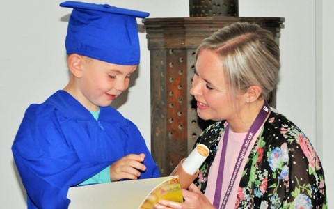 child graduating from nursery