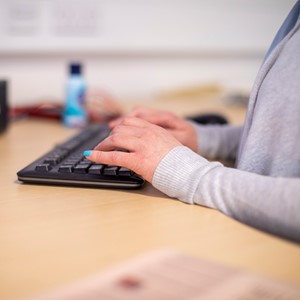 Accounting student hands working on computer