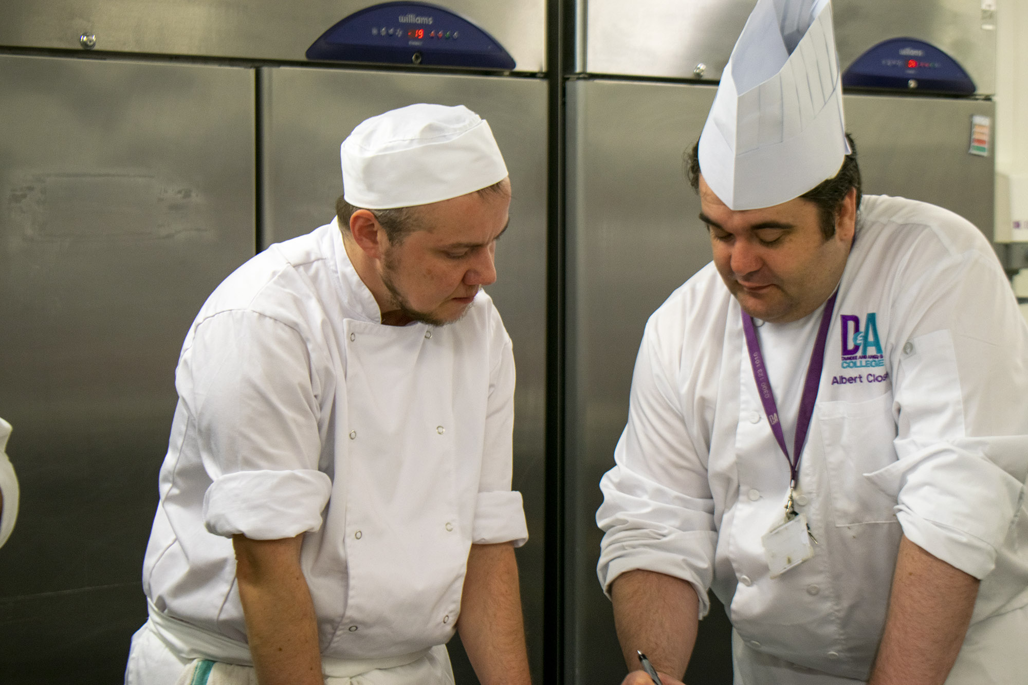 cookery students in kitchen