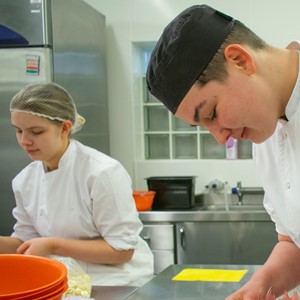 cookery students in kitchen