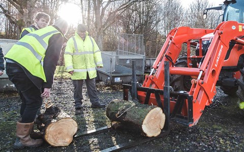 students working with tractor