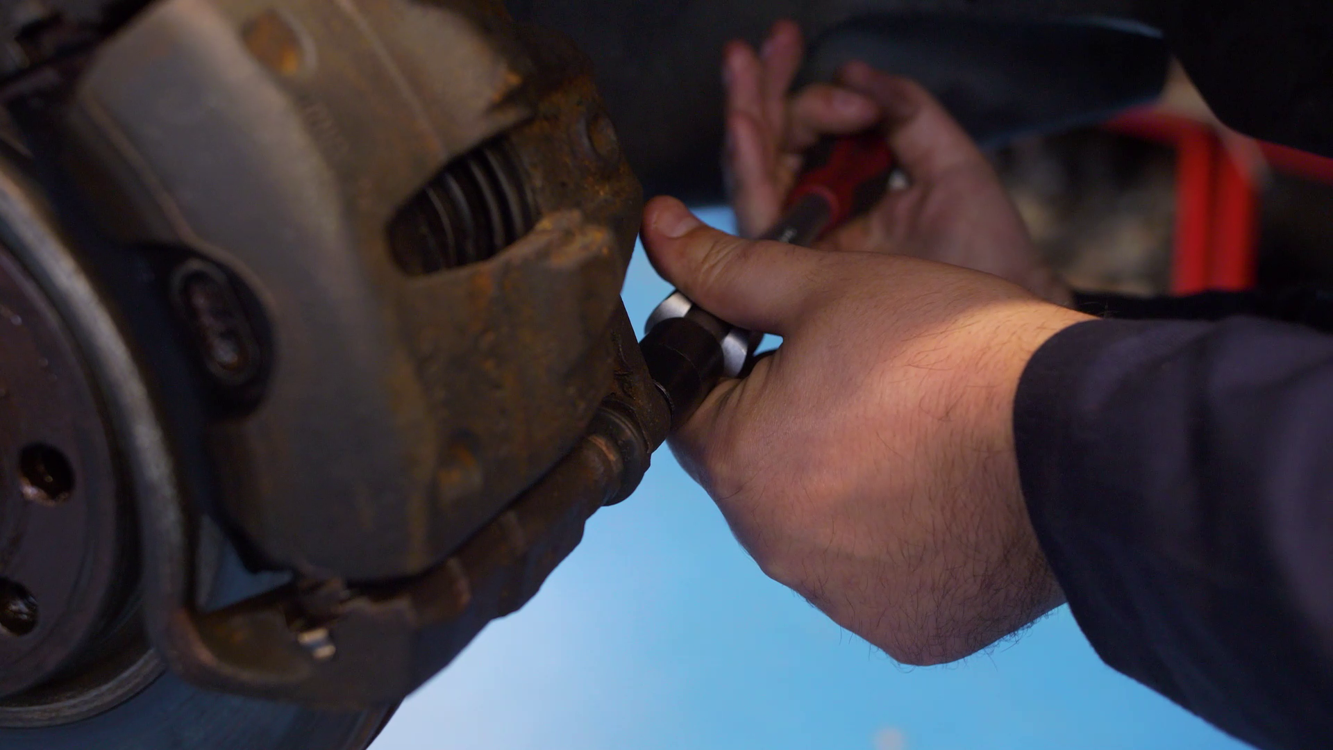 Motor Vehicle Student hands working on car brake