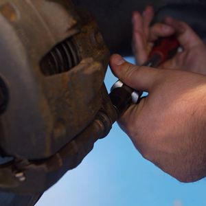 Motor Vehicle Student hands working on car brake
