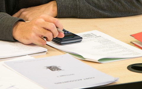 Student working on a calculator