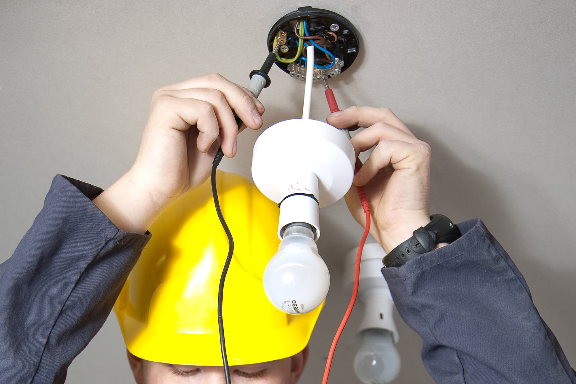 Electrician fitting roof light