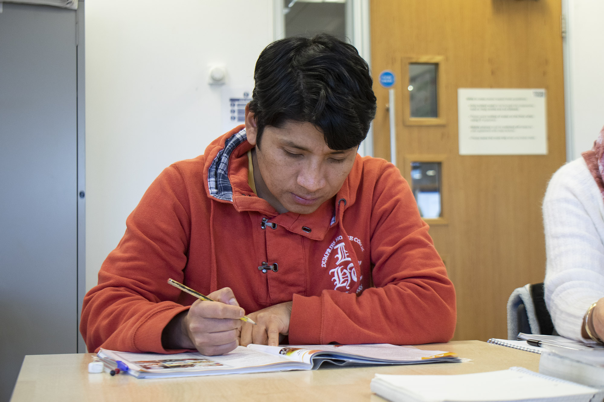 student writing and learning ESOL