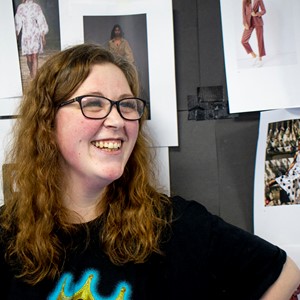 smiling student with fashion on the wall