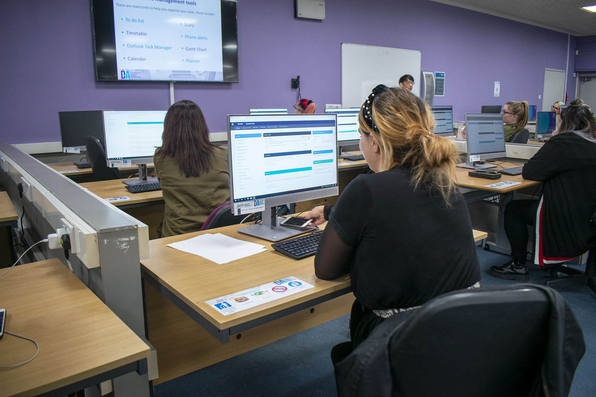 Business Administration and Information Technology students working on computers
