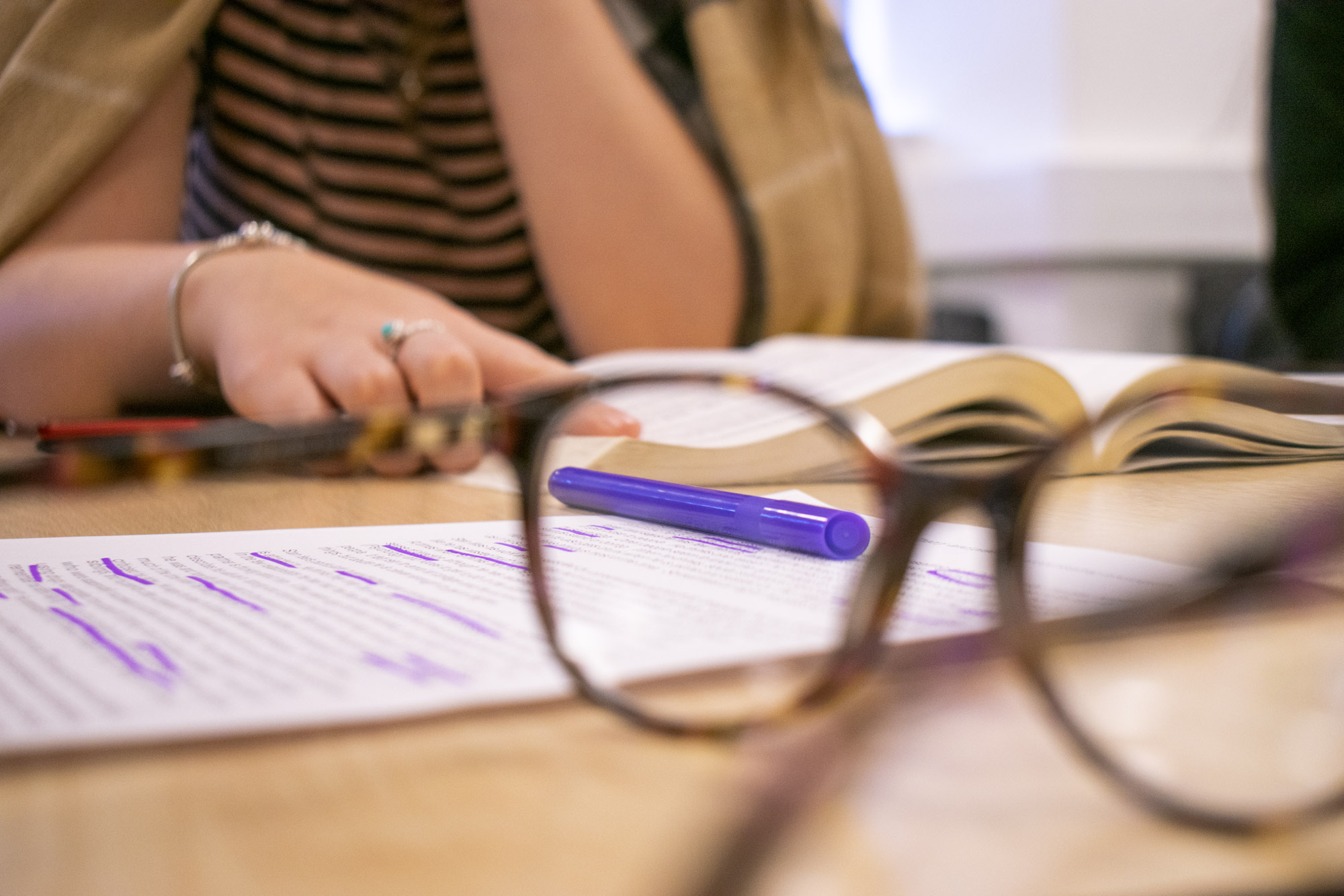 Glasses and paperwork on desk