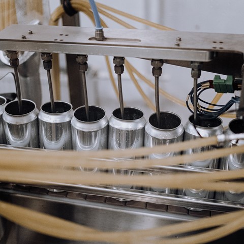 close up of cans being filled