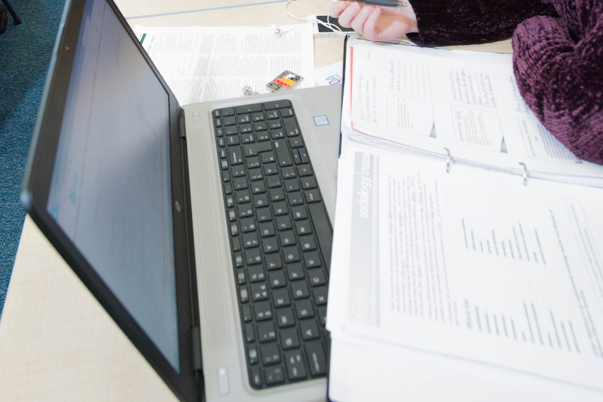 laptop and printed notes