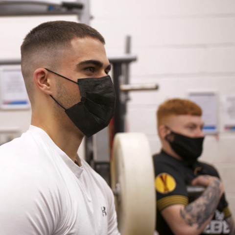 Sport students in gym area wearing face masks