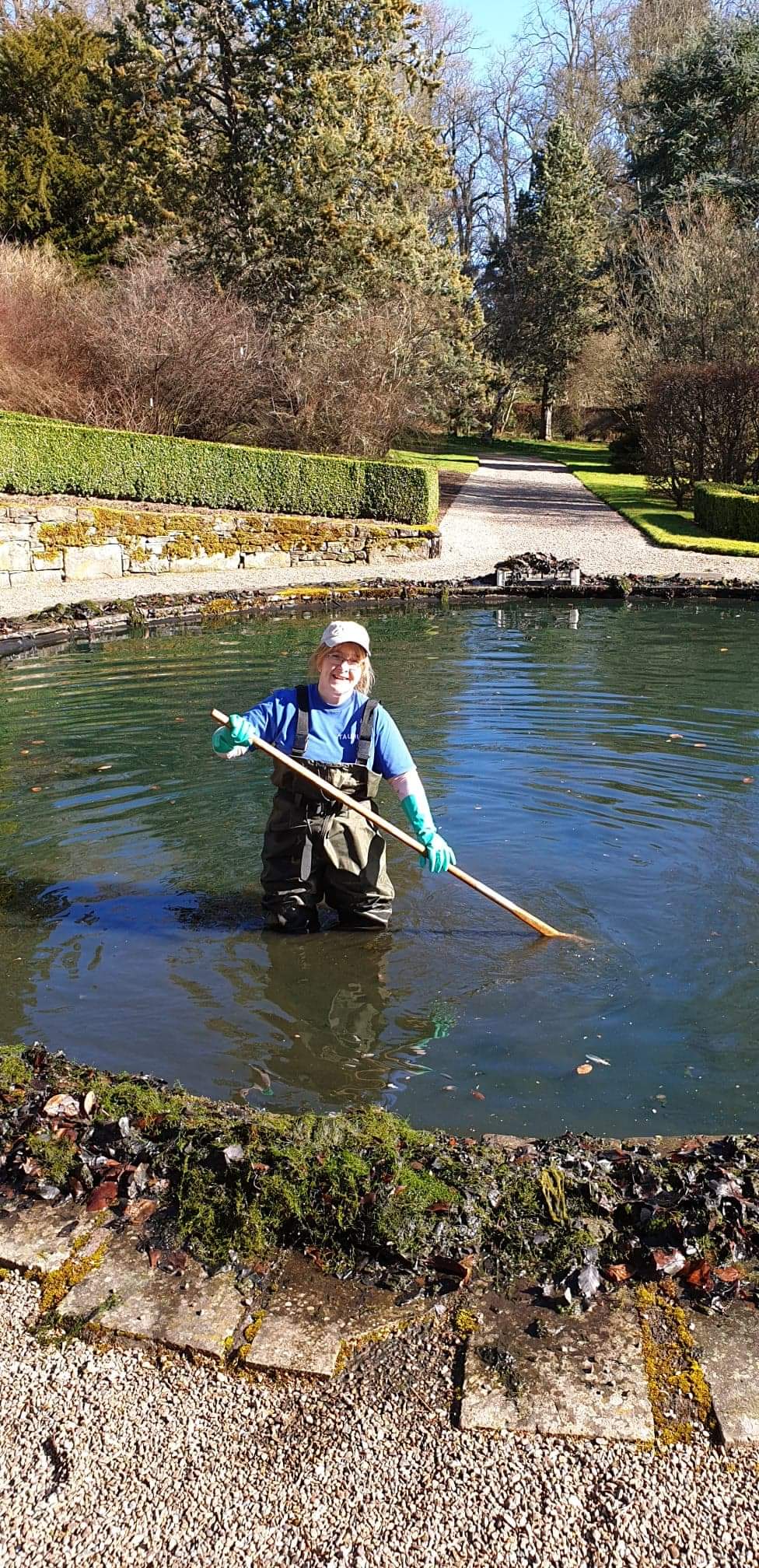Charlotte Paterson cleaning out a pond