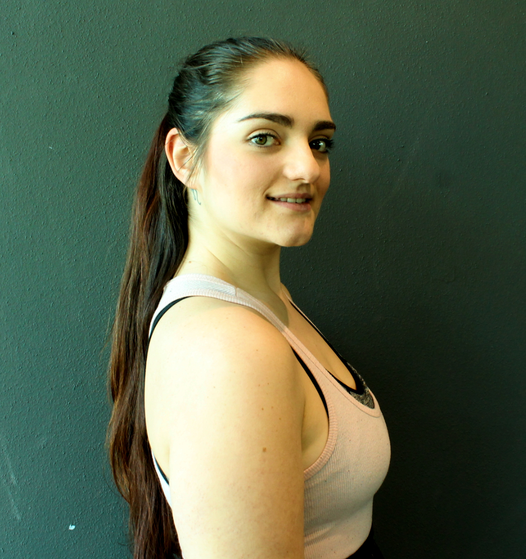 Chiara Cassarino posing by dark green wall