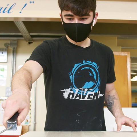 Painting student wearing a face covering