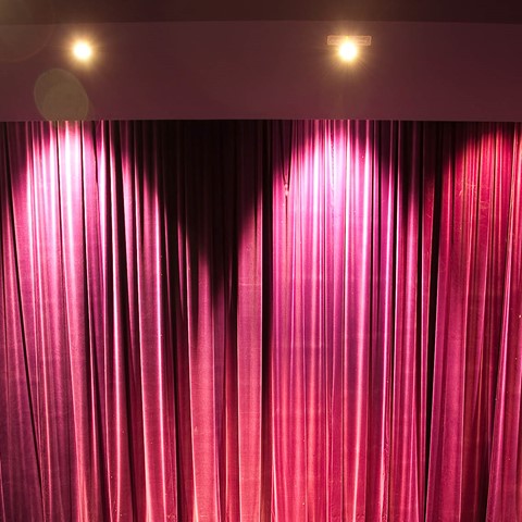 Gardyne Theatre curtains with spotlights on them