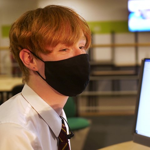School pupil at computer in college