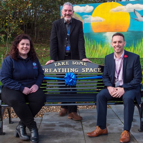 Amy Monks, Simon Hewwitt and the head of Breathing space sitting on the new bench