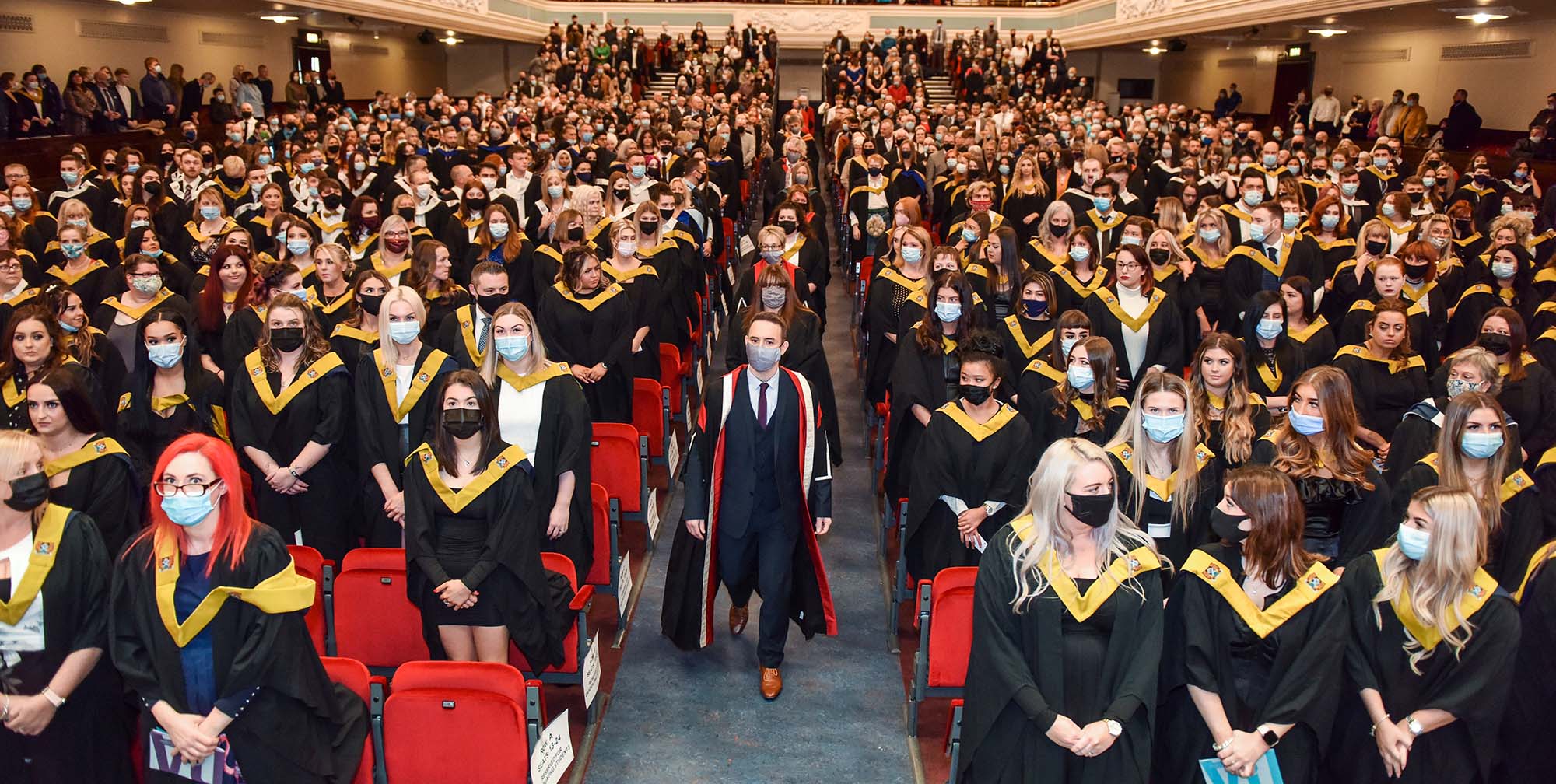 Platform party walking down Caird Hall central aisle