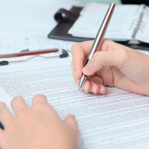 A woman signing a contract