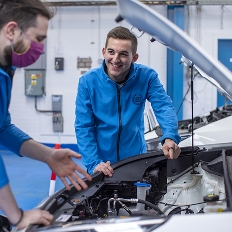 Science Centre Employees under the hood of an Electric Vehicle