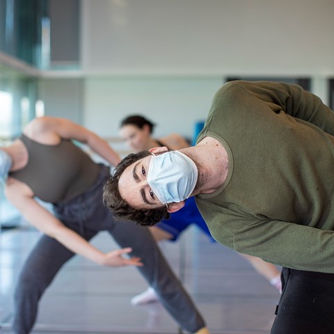dance lecturer leading class in some dynamic dance moves