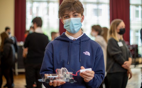 Student holding Hydrogen car model