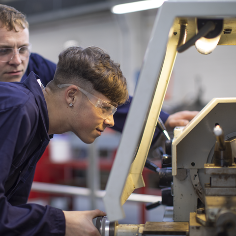 Manufacturing Academy student using Lathe
