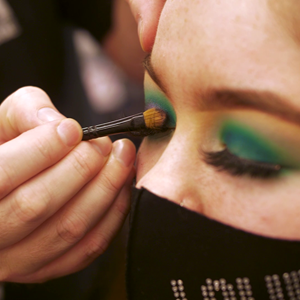 closeup of student having makeup applied