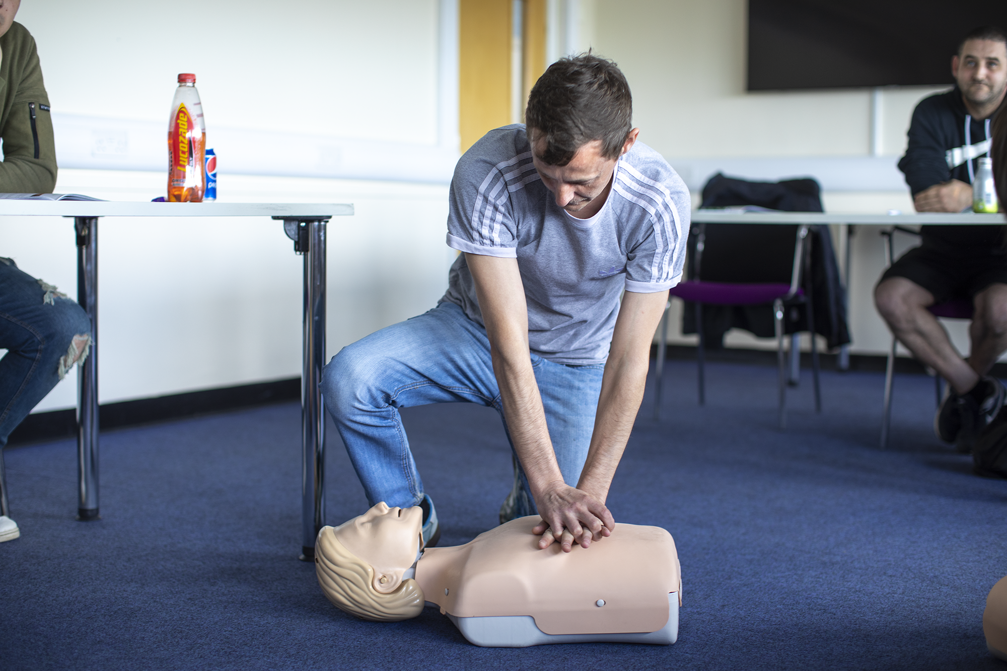 Student performing first aid on CPR dummy