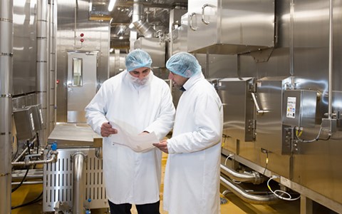 Staff next to ovens in 2 sisters factory