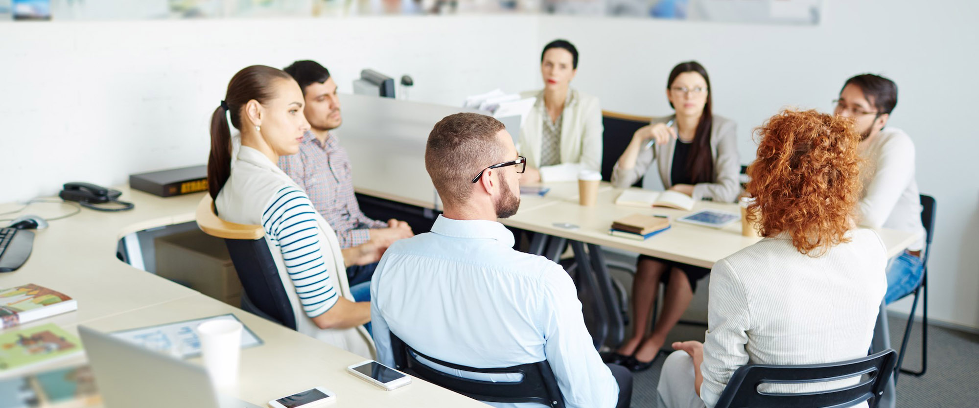 people in a work meeting around a table