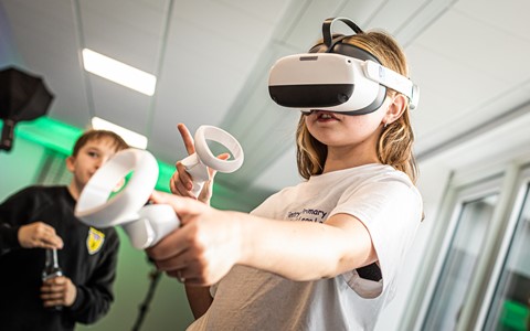 Children trying on VR Headsets