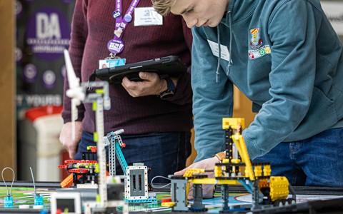 Pupil carrying out activity with Lego machine