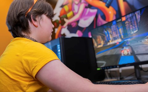 Child playing video game as part of E-Sports club