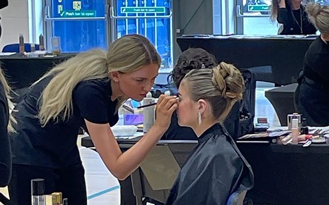 Student doing make up on girl during Scottish Hair and Beauty Competition