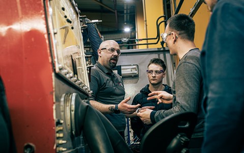 ATL Turbines member of staff talking to two students