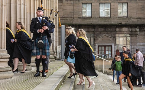 graduating students going into Caird Hall and piper