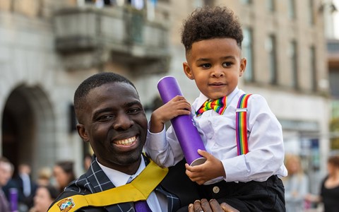 graduating student and child