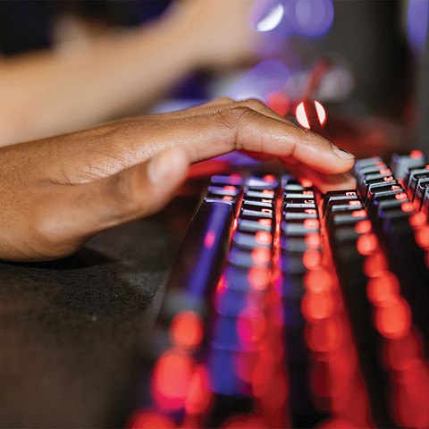 Person typing on gaming keyboard