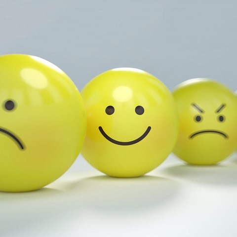 yellow balls with emotion faces