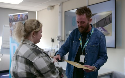 Student receiving certificate at BT EE Academy event