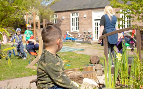 Helping Hands Nursery Child Sitting Outside