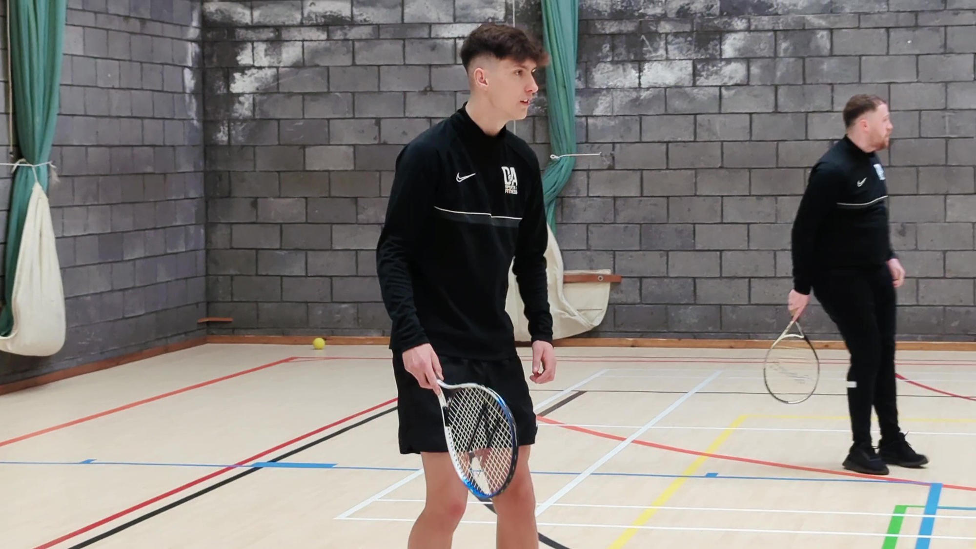Students playing indoor tennis