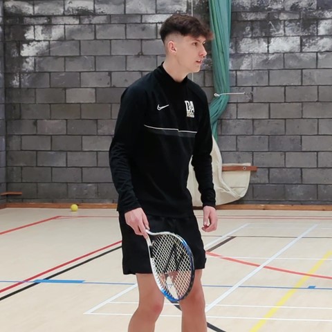 Students playing indoor tennis