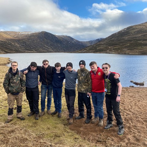 Group photo of students on Learner Engagement Team trip at loch.